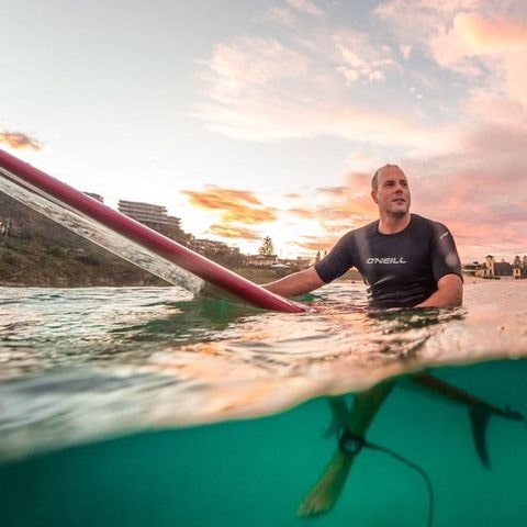 James Schramko on a surfboard 2021